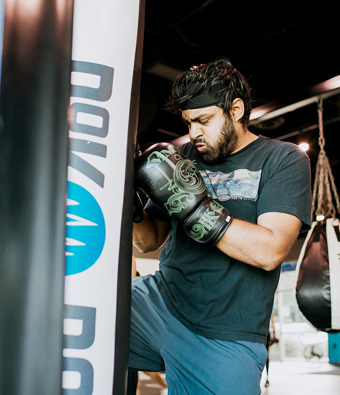 man boxing with hanging bag