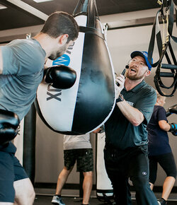 RockBox fitness trainer working with a member during a workout